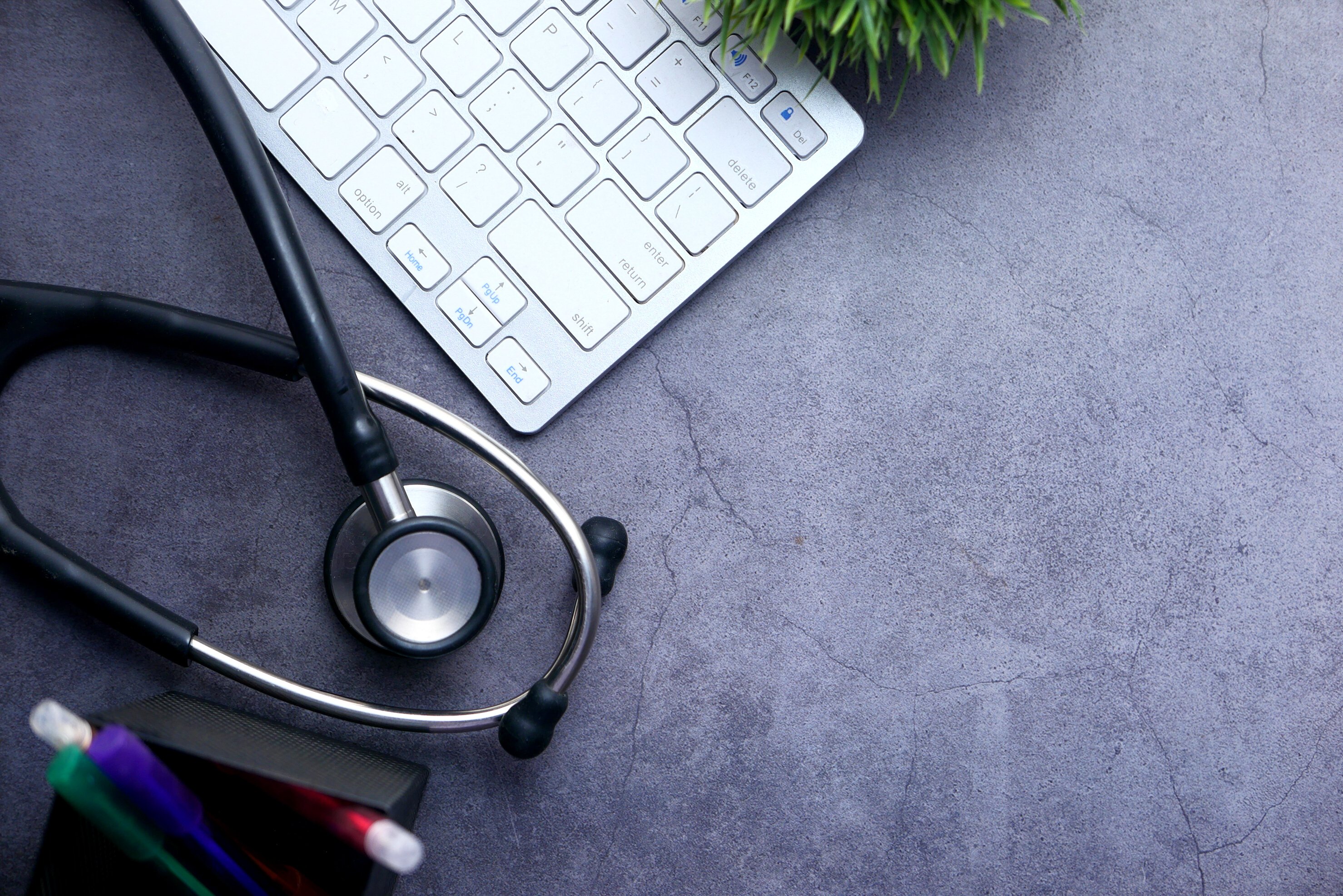 Medical Stethoscope and Keyboard on Black Background